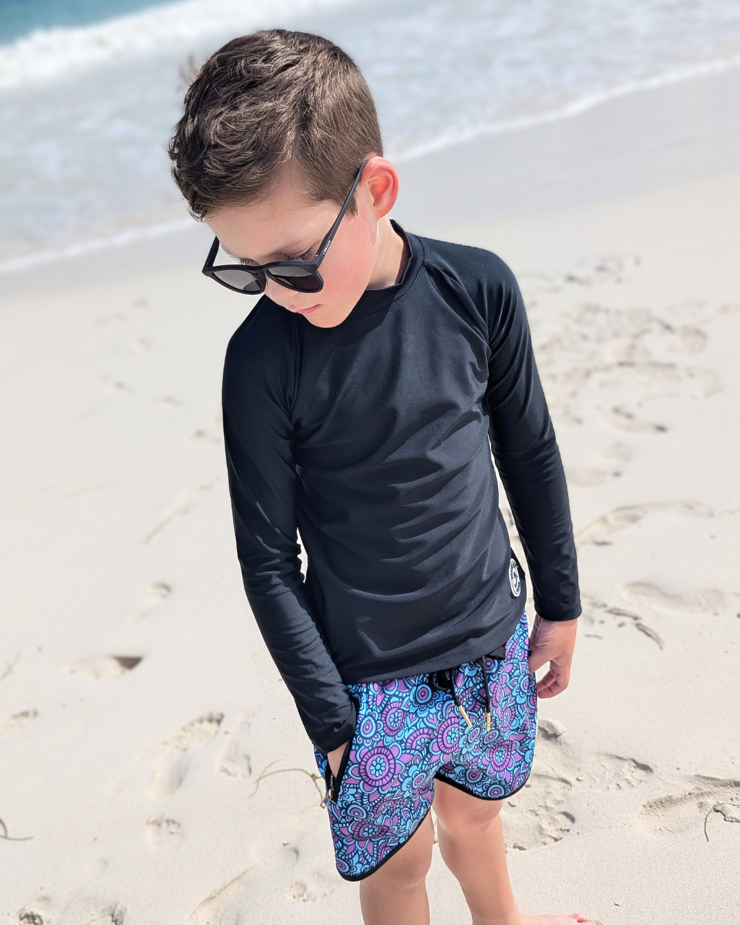 boy on beach in boys swimwear