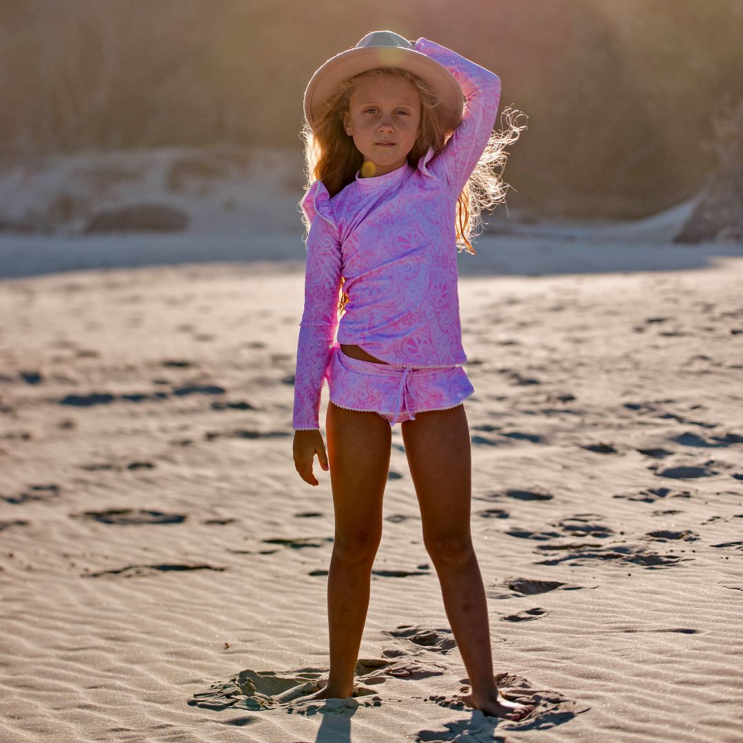Uniquely designed girls swimsuit, featuring a closed back rash top