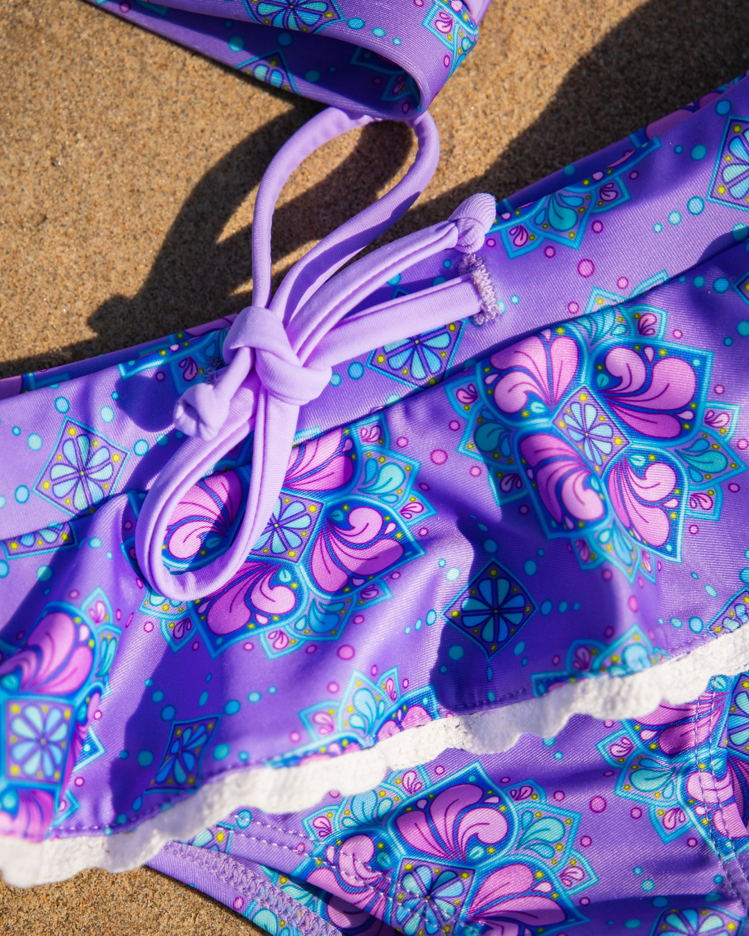 2 piece swimsuit for tweens with pattern on a sandy surface