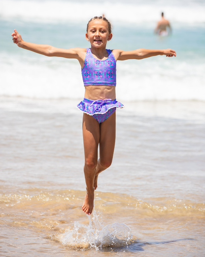 Girl jumping in tween bikini
