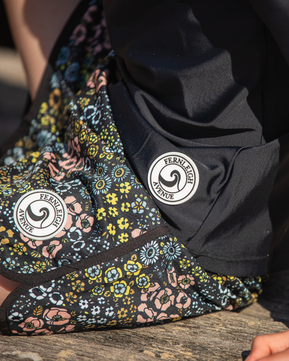 Close-up of boys board shorts with a visible brand logo.